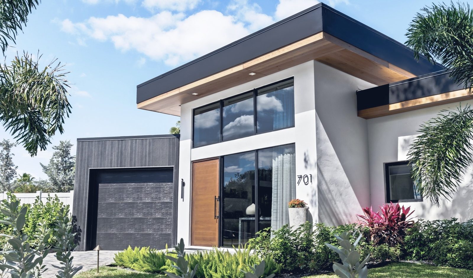 Wise Residence — extensive modern remodel with white stucco, dark cladding, and natural wood in Wilton Manors, Florida